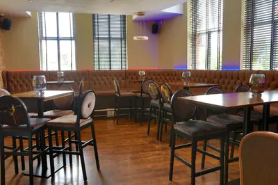 a row of tables and chairs in a restaurant at The Eccleston Hotel; BW Signature Collection in Saint Helens