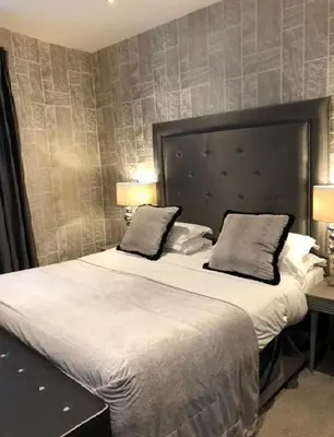 a bedroom with a large bed with two pillows at The Eccleston Hotel; BW Signature Collection in Saint Helens