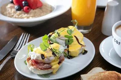 two plates of food on a table with breakfast foods at The Eccleston Hotel; BW Signature Collection in Saint Helens