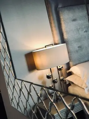 a bedroom with a mirror and a lamp next to a bed at The Eccleston Hotel; BW Signature Collection in Saint Helens