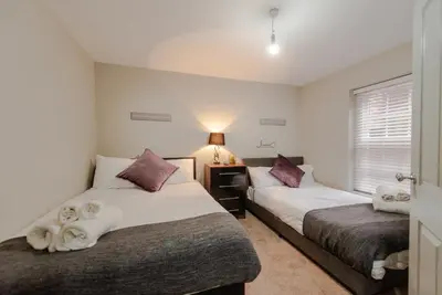 a bedroom with two beds and a lamp in it at Infinity St Ives Grove- With Street Parking in Liverpool