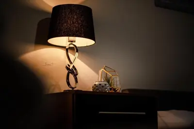 a lamp on top of a dresser in a bedroom at Infinity St Ives Grove- With Street Parking in Liverpool