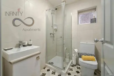 a bathroom with a shower and a toilet and a sink at Infinity St Ives Grove- With Street Parking in Liverpool