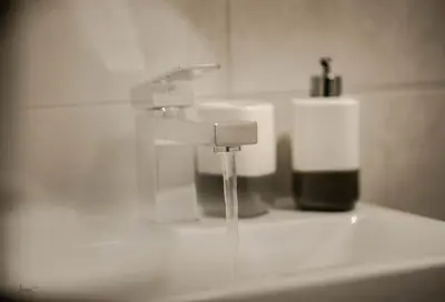 a bathroom sink with water dripping from a faucet at Infinity St Ives Grove- With Street Parking in Liverpool