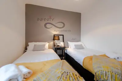 two beds sitting next to each other in a room at Infinity St Ives Grove- With Street Parking in Liverpool