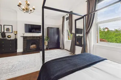 a bedroom with a canopy bed and a fireplace at Host & Stay - Beech Street in Liverpool