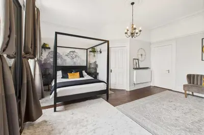a bedroom with a bed and a chandelier at Host & Stay - Beech Street in Liverpool