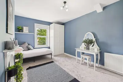 a blue room with a couch and a mirror at Host & Stay - Beech Street in Liverpool
