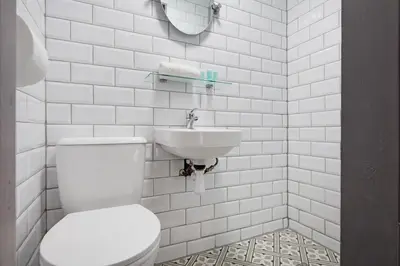 a white bathroom with a toilet and a sink at Anfield Nest - Air Host & Stay - 3 bed 3 bath in Liverpool