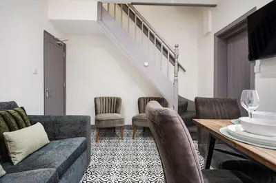 a living room with a couch and chairs and a table at Anfield Nest - Air Host & Stay - 3 bed 3 bath in Liverpool