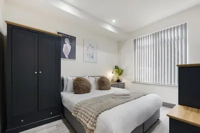 a bedroom with a bed and a large window at Anfield Nest - Air Host & Stay - 3 bed 3 bath in Liverpool