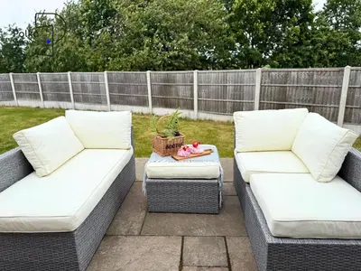 two wicker couches sitting on a patio at No 8 PolkaStays Ivy Farm Primrose Deluxe in Brown Moss Side