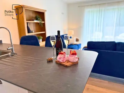 a counter with two wine glasses and wine bottles at No 8 PolkaStays Ivy Farm Primrose Deluxe in Brown Moss Side