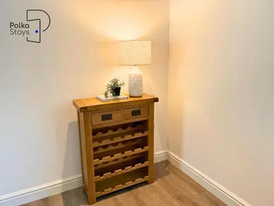 a side table with a lamp on top of it at No 8 PolkaStays Ivy Farm Primrose Deluxe in Brown Moss Side
