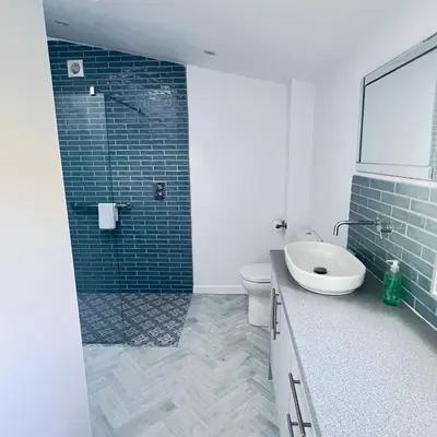 a bathroom with a sink and a toilet and a shower at Thwaite Croft - Carnforth in Carnforth