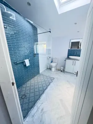 a bathroom with a glass shower with a toilet at Thwaite Croft - Carnforth in Carnforth