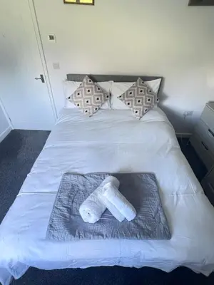 a white bed with a towel on top of it at Thwaite Croft - Carnforth in Carnforth