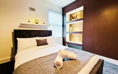 a bedroom with a bed with a towel on it at Lodginet Stays - County View - 1BR Flat 4 in Liverpool