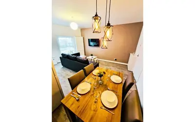 a dining room and living room with a wooden table at Lodginet Stays - County View - 1BR Flat 4 in Liverpool