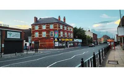 an empty city street with a red brick building at Lodginet Stays - County View - 1BR Flat 4 in Liverpool
