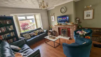 a living room with couches and a fireplace at Stay your way in Huyton with Roby
