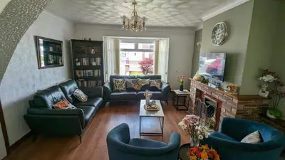a living room with couches and a fireplace at Stay your way in Huyton with Roby