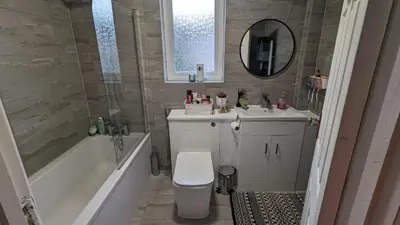 a bathroom with a toilet and a tub and a sink at Stay your way in Huyton with Roby