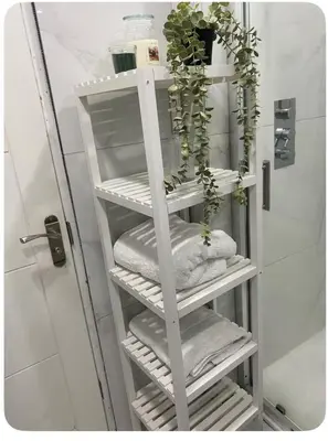 a white towel rack with towels and a plant at Twinhorse in Prescot