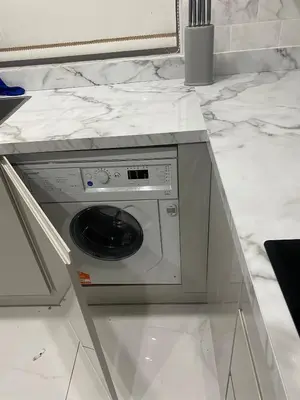 a washing machine in a counter in a kitchen at Twinhorse in Prescot