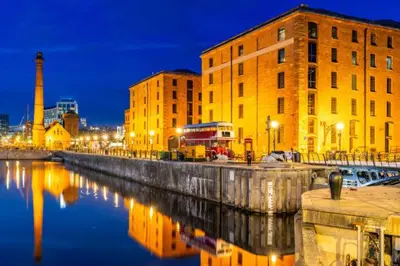 a city with buildings and a river at night at 2 bed GF Docklands Apartment - Free Parking for 1 car in Liverpool