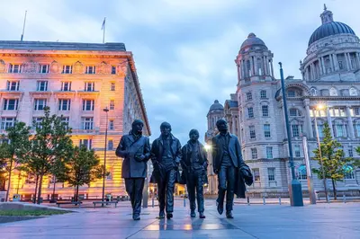 a statue of a group of people walking in front of a building at 2 bed GF Docklands Apartment - Free Parking for 1 car in Liverpool