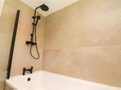 a bathroom with a shower with a bath tub at Heron View in Preston
