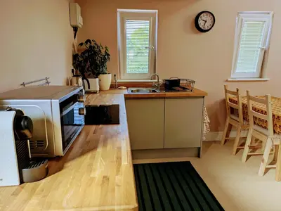 a kitchen with a sink and a microwave in it at Field Edge Barn in Silverdale