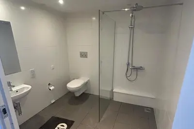 a bathroom with a shower and a toilet and a sink at Central 1-Bed Studio Sleeps 2 with City Views in Liverpool