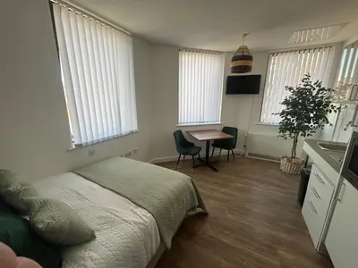 a bedroom with a bed and a table in it at Central 1-Bed Studio Sleeps 2 with City Views in Liverpool