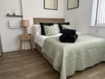 a bedroom with a bed with a black pillow on it at Central 1-Bed Studio Sleeps 2 with City Views in Liverpool