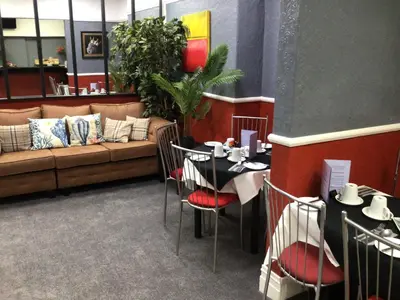 a restaurant with a couch and a table and chairs at White Swallow Hotel in Blackpool
