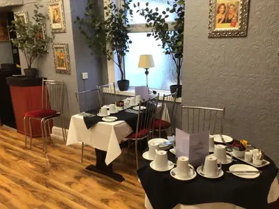 a room with a table with cups and plates on it at White Swallow Hotel in Blackpool