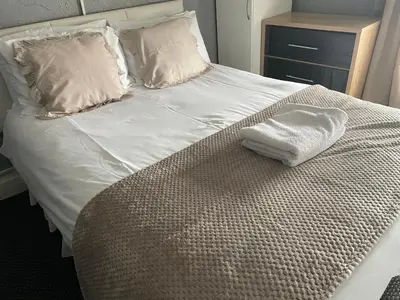 a bed with a white towel sitting on it at Somerville Hotel in Blackpool
