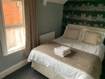 a bedroom with a bed with towels on it at Somerville Hotel in Blackpool
