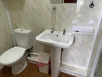 a bathroom with a toilet and a sink at Somerville Hotel in Blackpool