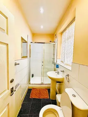 a bathroom with a shower and a toilet and a sink at The Cabbage Hall Hotel in Liverpool
