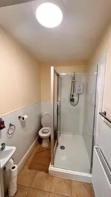 a bathroom with a shower and a toilet and a sink at The Cabbage Hall Hotel in Liverpool