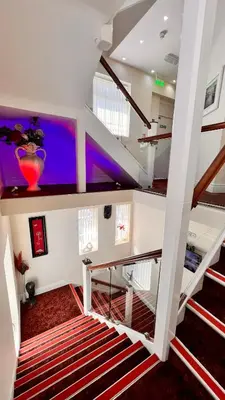 a staircase in a house with a purple ceiling at The Cabbage Hall Hotel in Liverpool