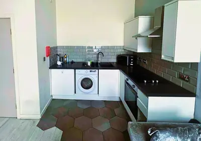 a kitchen with a sink and a washing machine at Urban Nest Liverpool Near Cavern Quarter sleeps in Liverpool