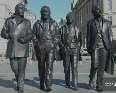 a statue of three men and a woman at Anfield Stadium House - Free Parking in Liverpool