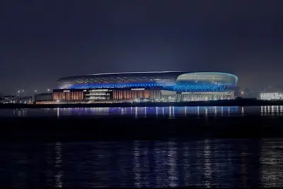 a large building with a blue roof on top of the water at Anfield Stadium House - Free Parking in Liverpool
