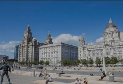 a group of people in front of a large building at Anfield Stadium House - Free Parking in Liverpool