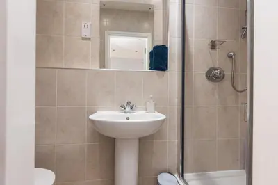 a bathroom with a sink and a shower at Lytham St Annes Luxury Apartment - No 1 Tides Reach in Lytham St Annes