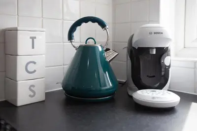 a green kettle on a counter next to a blender at Lytham St Annes Luxury Apartment - No 1 Tides Reach in Lytham St Annes